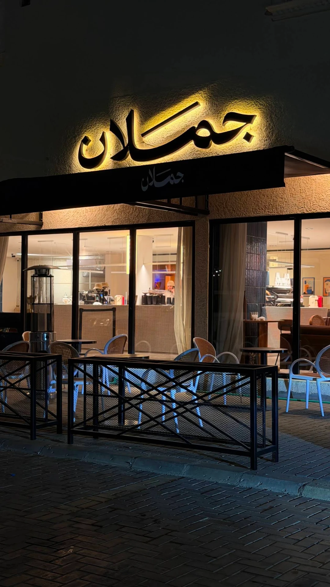 واجهة مقهى جملان المضاءة في رفحاء ليلاً